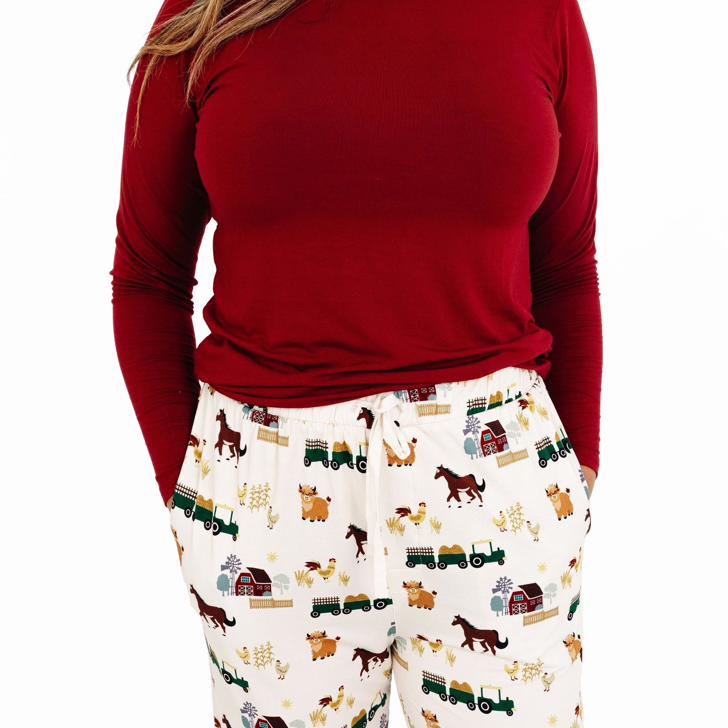Close up of woman wearing On the Farm bamboo relaxed lounge pajama pants with barnyard animal and tractor print, hypoallergenic fabric.