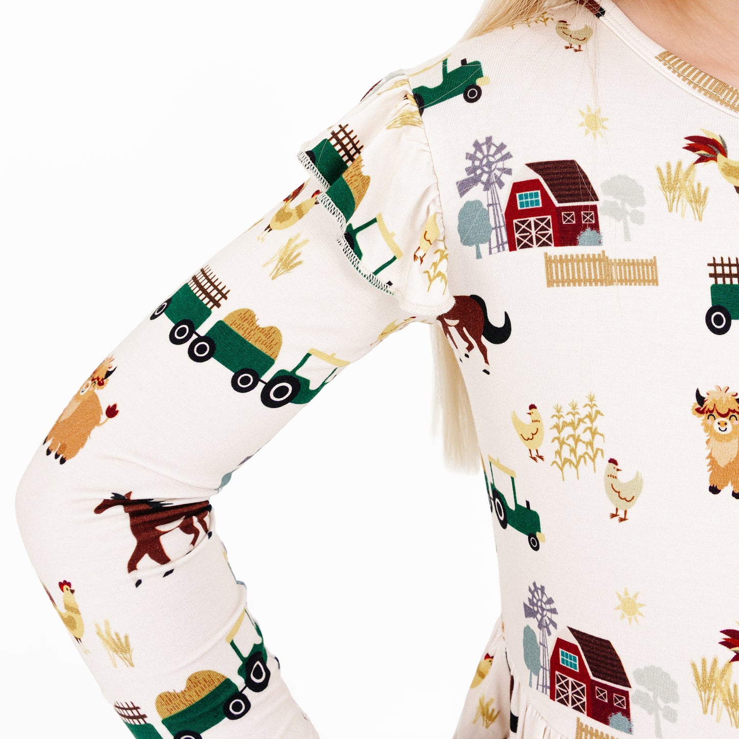 On the Farm bamboo ruffled twirl dress close-up fabric detail with horses, cows, barns, and tractors, breathable and hypoallergenic.