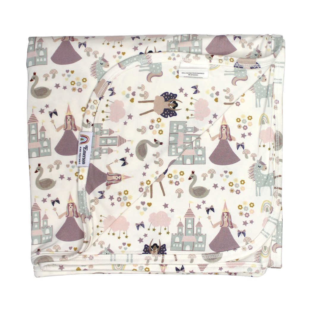 the "once upon a time" bamboo blanket. the "once upon a time" print is a mix of pinks, purples, whites, blues, and yellows. you can see fairy princess and regular princess, unicorns, swans, and castles. theres also hearts, stars and sparkles scattered around the print.