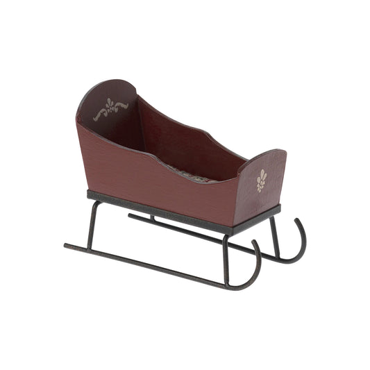 Brown sleigh with decorative elements on a white background