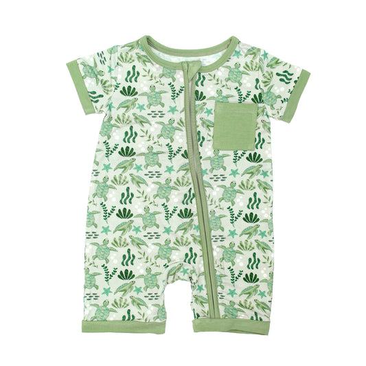 Save the Sea Turtles bamboo baby shortie romper by Emerson and Friends. This soft and breathable short-sleeve romper features a charming ocean-inspired turtle print, a front zipper for easy changes, and a cozy pocket detail.