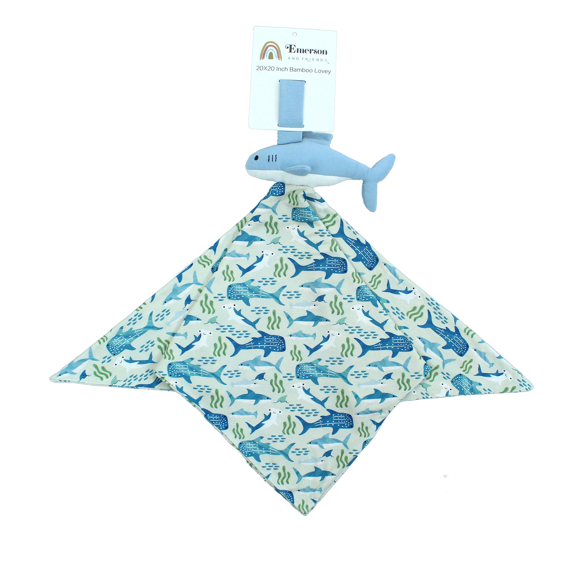 Flat lay image of the Shark Friends Baby Bamboo Lovey. The lovey has a velcro band to attach to car seats, cribs and wrists. Below the velcro, is a shark stuffy with a square sized bamboo blanket attached under the sharks white belly.