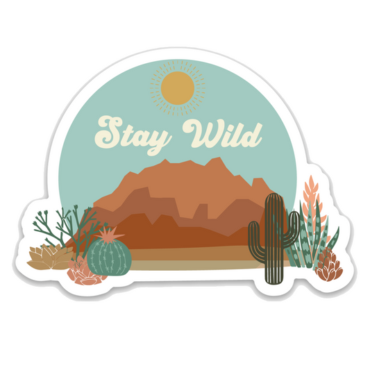 western and desert styled sticker that says "stay wild." you can see a canyon, rocks, and cacti.