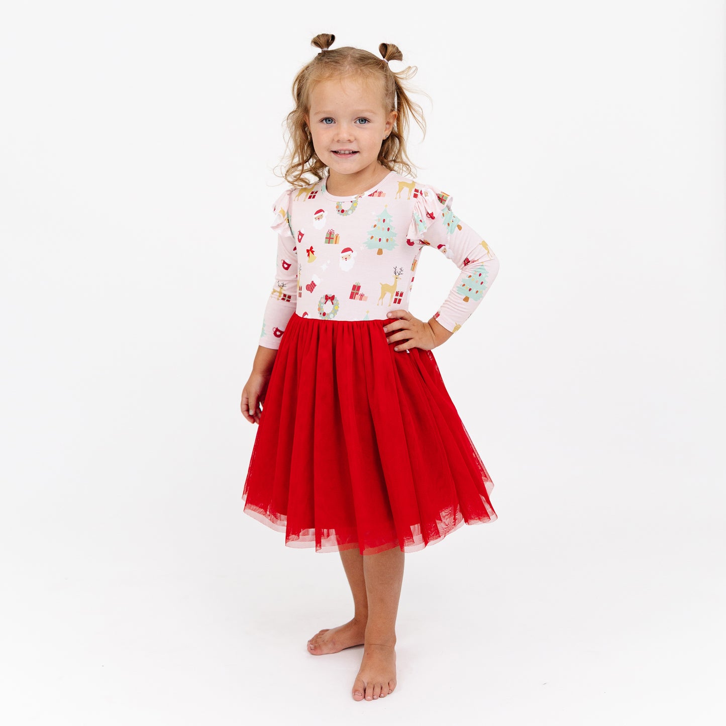 Child poses with hands on hips in Sugar Plum bamboo tulle dress, perfect for holiday photos and special occasions.