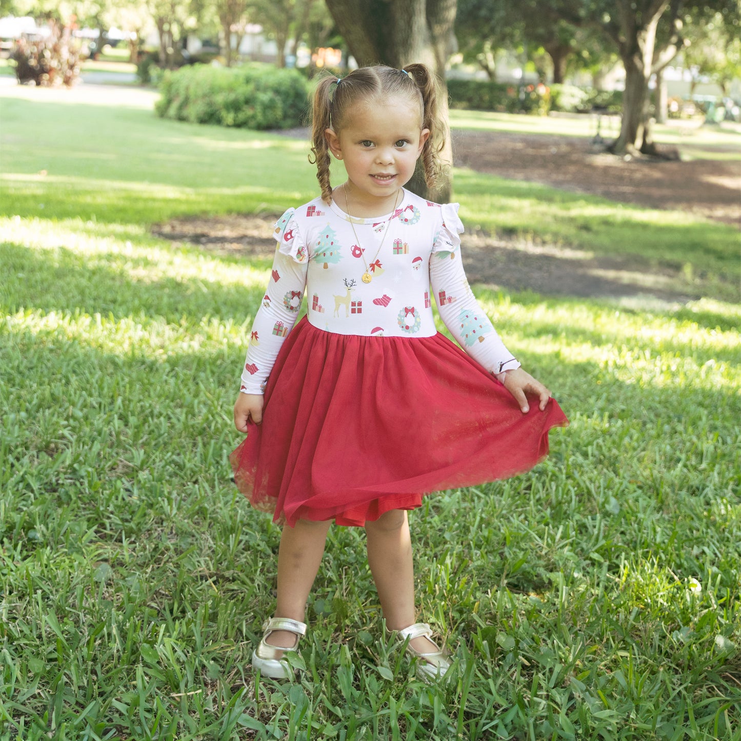 Girl wearing Sugar Plum bamboo tulle dress plays outdoors, showing off the soft bamboo fabric and flowy skirt.