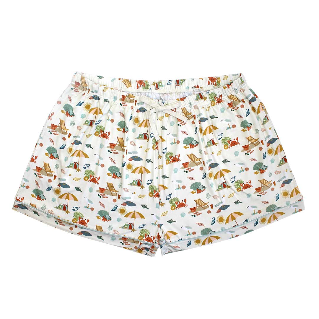 the "beach days" women's pajama shorts. the "beach days" print is a scattered print of beach umbrellas, beach balls, sand buckets and shovels, coral, shells, beach chairs, seagulls, flipflops, and sunglass mixed in a orderly and creative way.