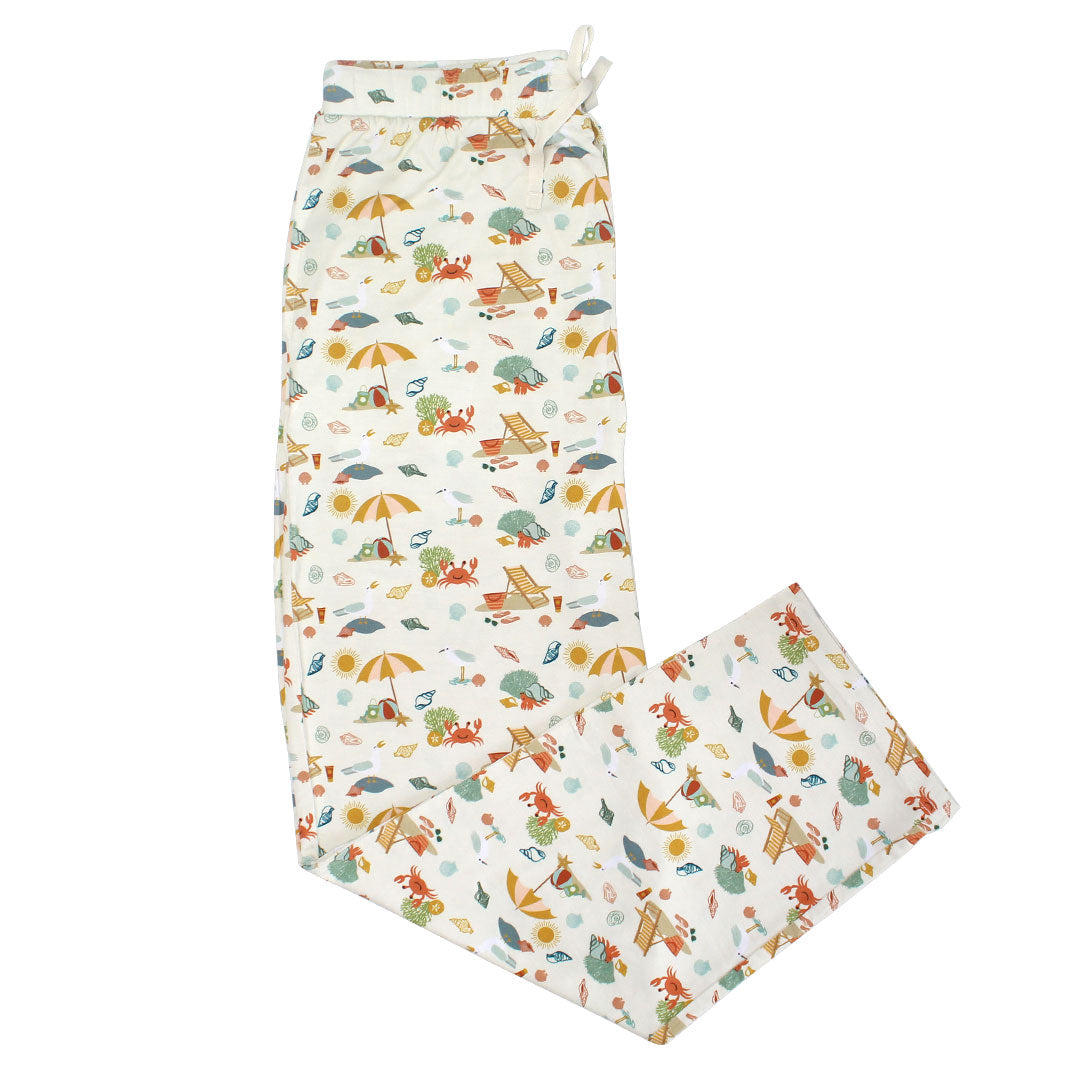 the "beach days" relaxed loungewear pants. the "beach days" print is a scattered print of beach umbrellas, beach balls, sand buckets and shovels, coral, shells, beach chairs, seagulls, flipflops, and sunglass mixed in a orderly and creative way.