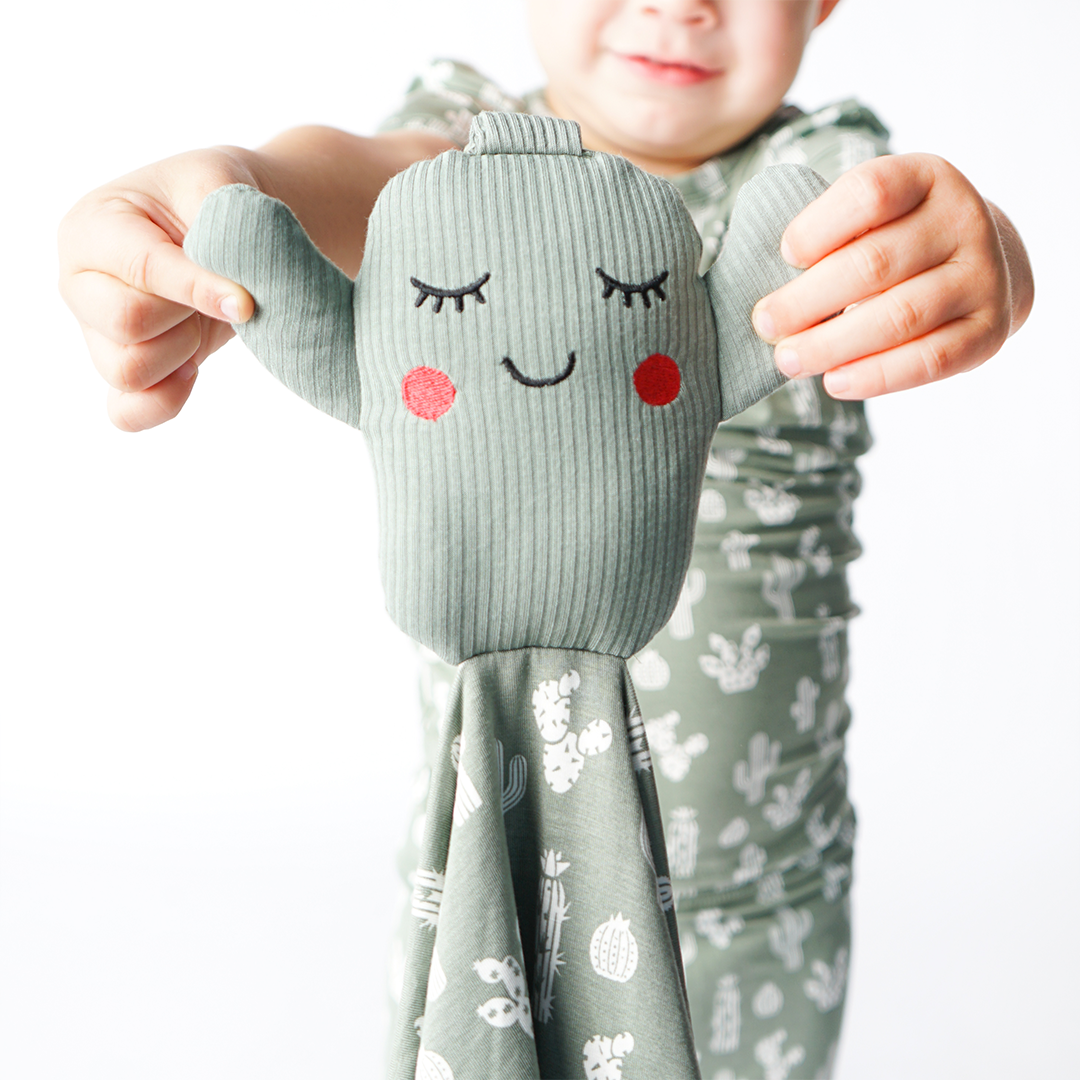 the "stay sharp" lovey. the "stay sharp" print is a variety of different white cacti on a greyish/green background.