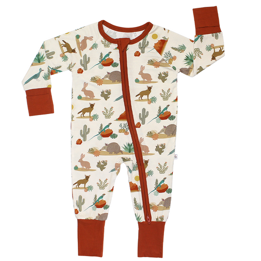 the "desert friends" convertible. the "desert friends" print is a scattered pattern of armadillo, cacti, other desert plants, rocks, desert foxes, lizards, and desert birds. this is all on a beige background.
