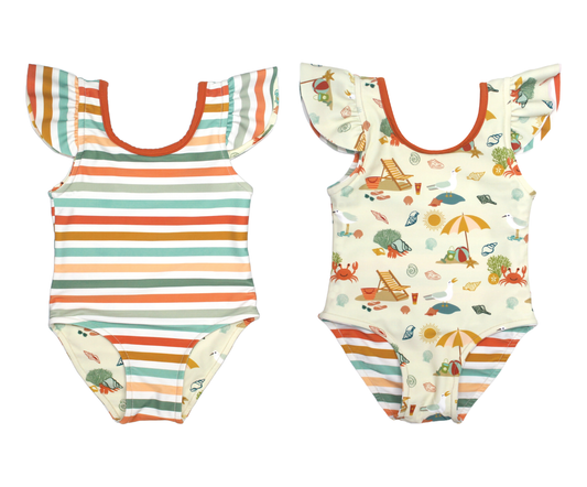 the 2 versions of the "beach days" reversible one piece. one version of it is the coral stripes print and the other is the "beach days" print.