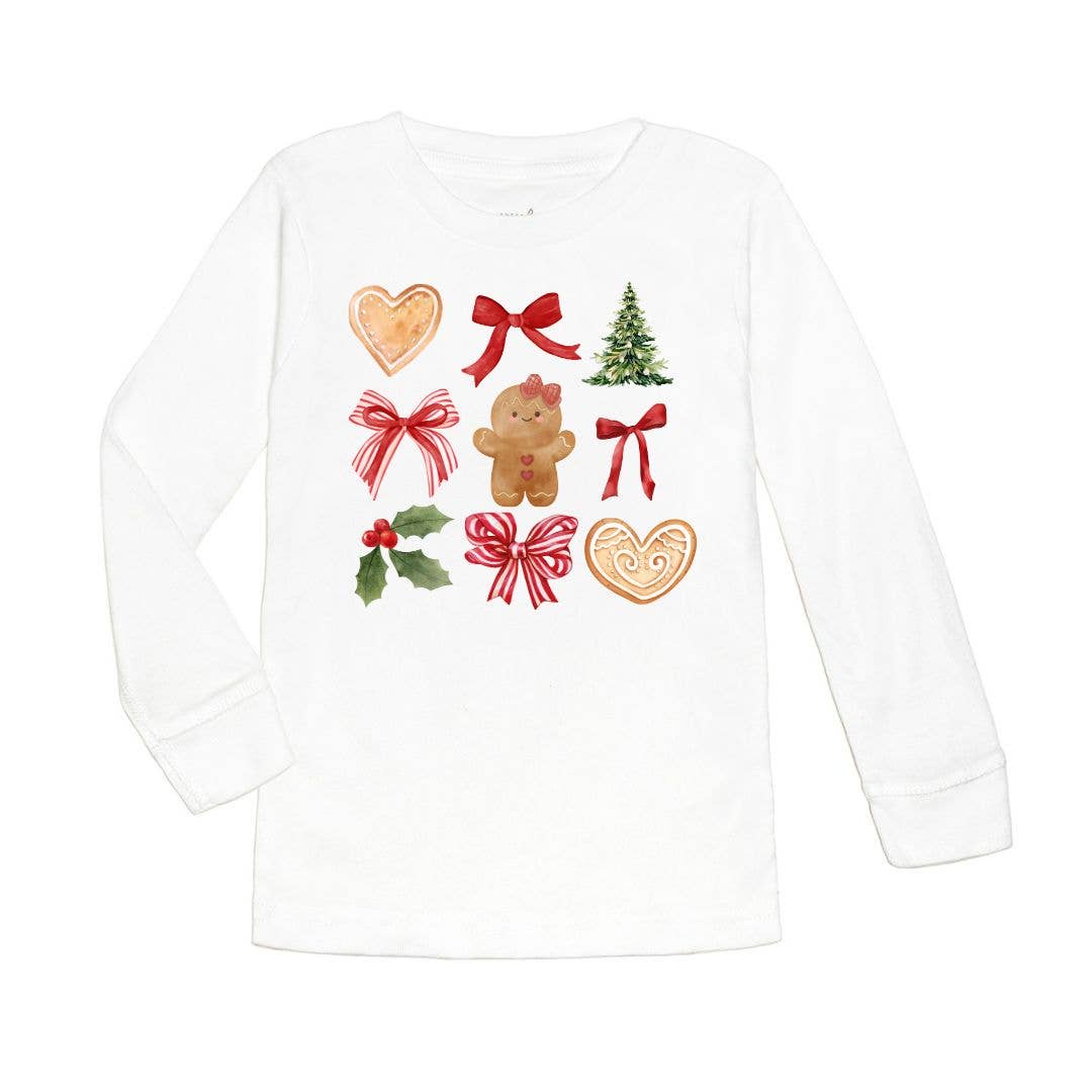 White long-sleeve shirt decorated with festive Christmas graphics including a gingerbread girl, red bows, holly leaves with berries, a Christmas tree, and heart-shaped cookies.