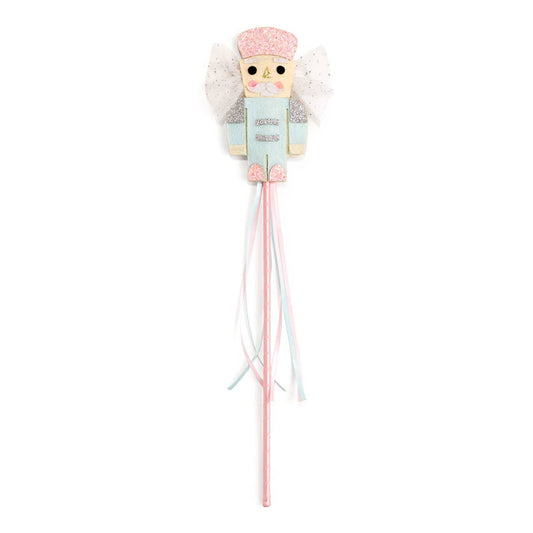 Nutcracker-themed Christmas wand featuring a pastel pink and blue nutcracker figure with glitter accents, white tulle wings, and long pastel ribbon streamers hanging from the handle.