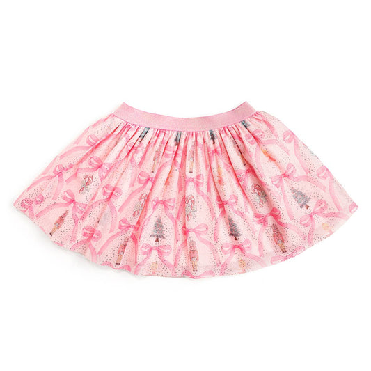 Pink tulle tutu skirt with a sparkly pink waistband, decorated with a festive print of nutcrackers, Christmas trees, candy canes, and bows in a trellis-style pattern with scattered glitter accents.