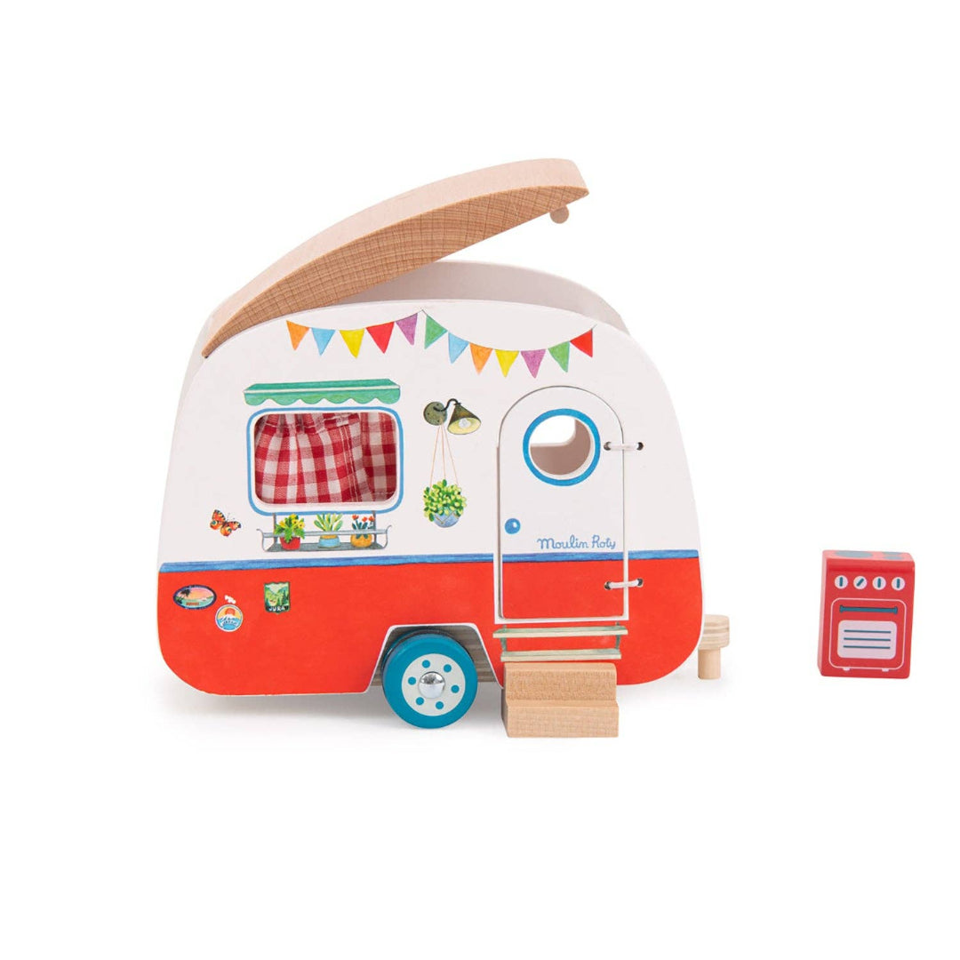 a wooden toy caravan thats red along the bottom white white at the top, it has a door on the front and a window and a removable roof