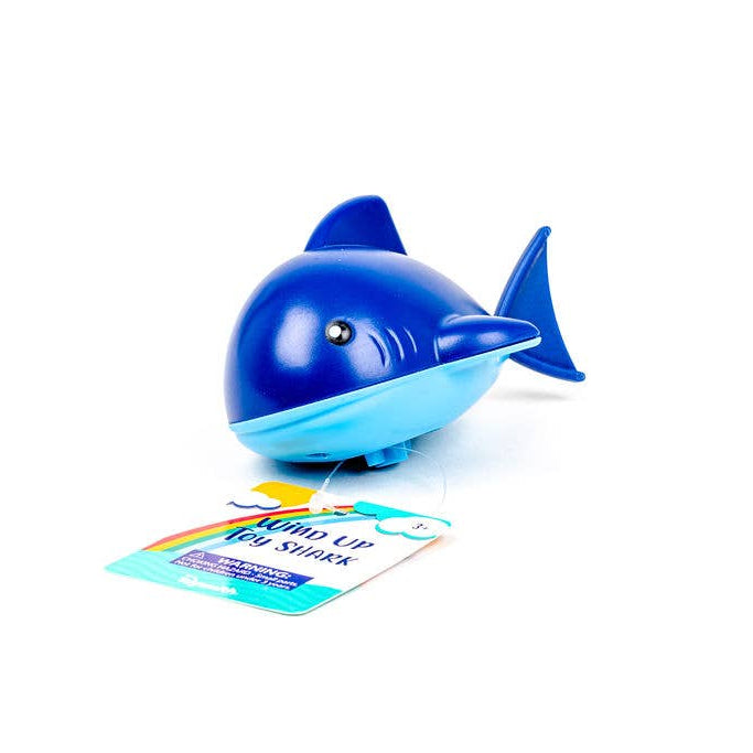 Blue whale-shaped toy with a card on a white background