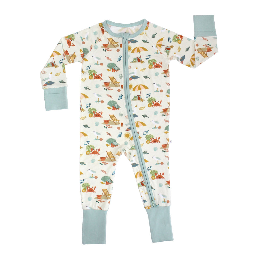 the "beach days" convertible. the "beach days" print is a scattered print of beach umbrellas, beach balls, sand buckets and shovels, coral, shells, beach chairs, seagulls, flipflops, and sunglass mixed in a orderly and creative way.
