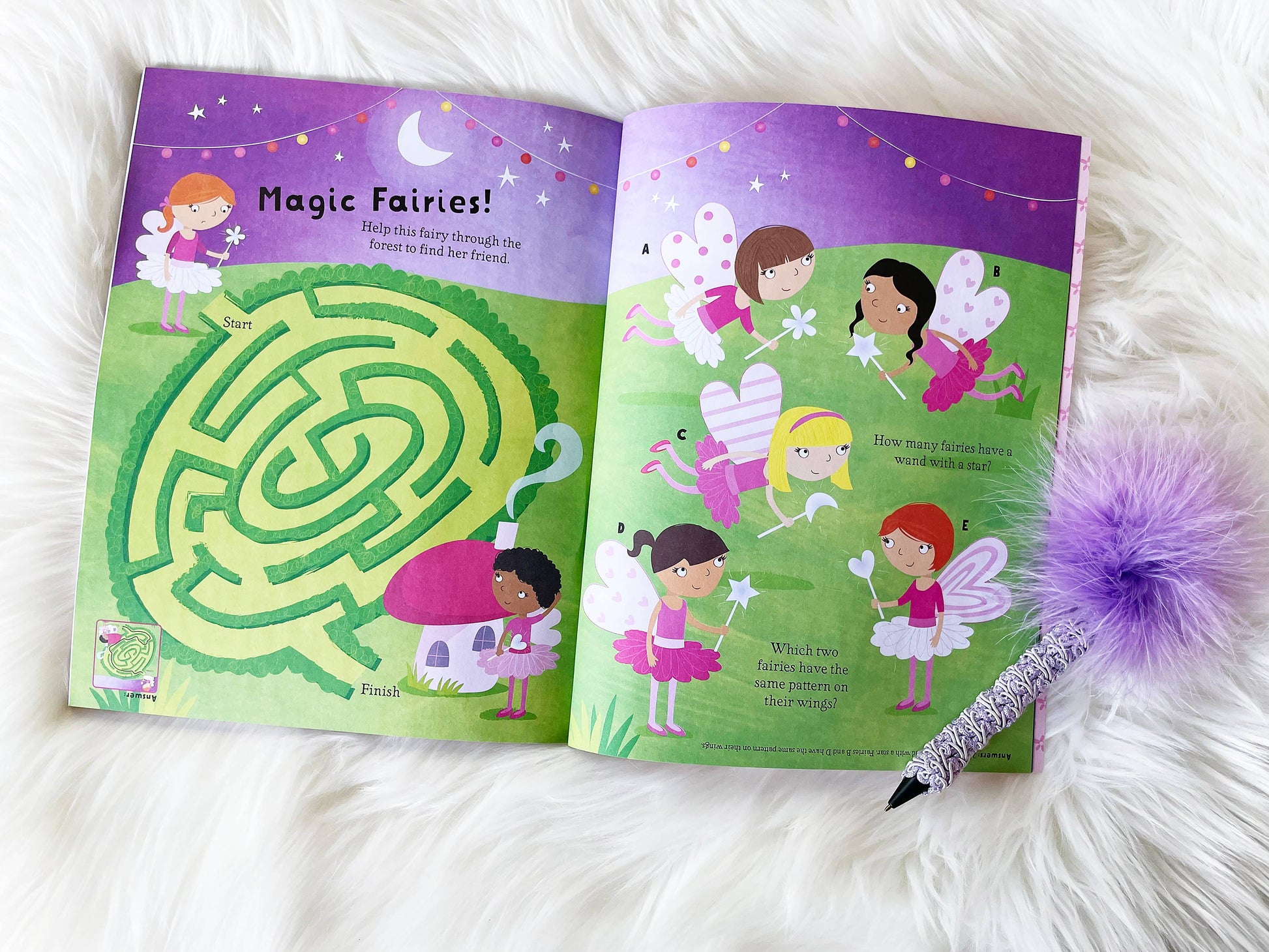 Open book with fairy-themed activities on a white surface