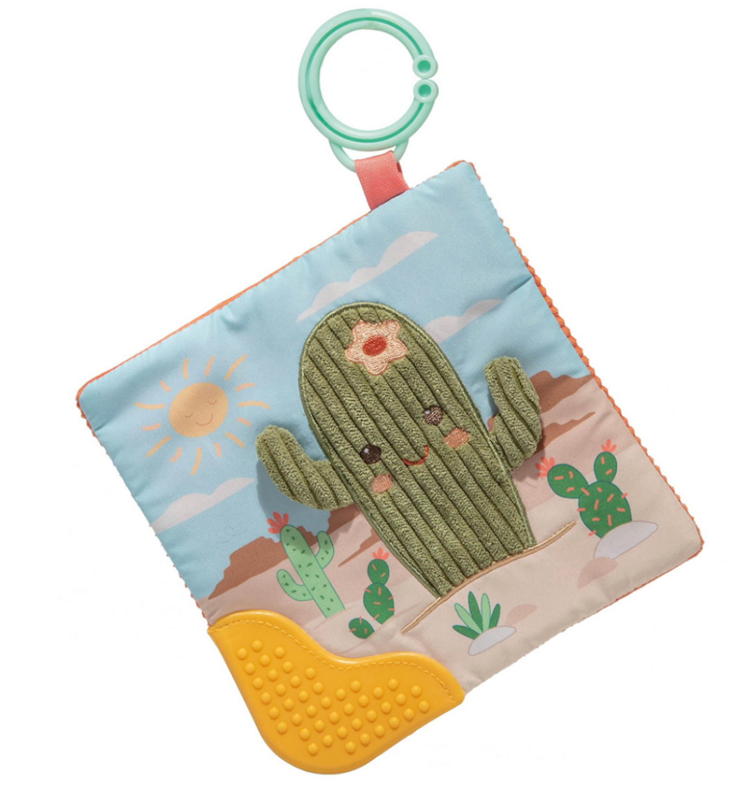 Pronounced soft cactus on a square cloth with crinkled paper and squeaker inside.  Desert background.  Corner has a plastic yellow teether.