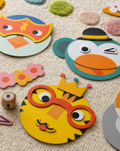 Colorful animal-themed cardboard masks on a textured surface