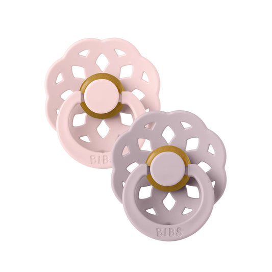 Two baby pacifiers, one pink and one gray, with gold centers on a white background.