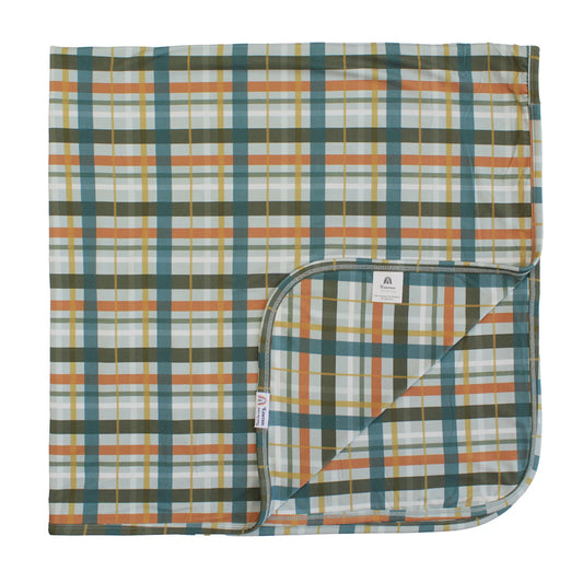 blanket with plaid print on white background.