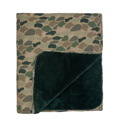 bamboo blanket with camo print and green fleece lining on white background.