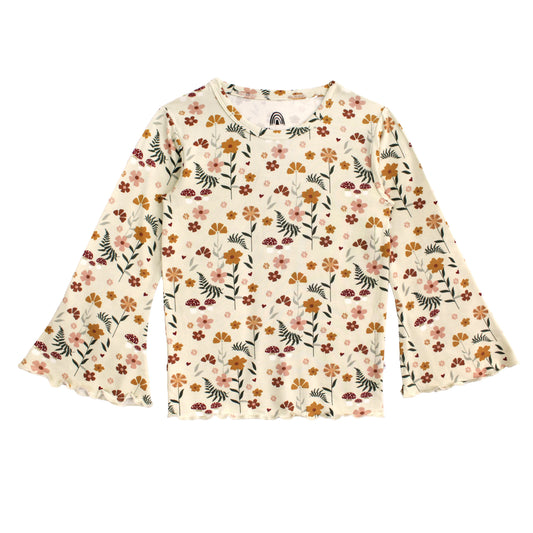 A long-sleeve cream-colored blouse with a dense, all-over floral and botanical print in orange, pink, green, and brown, featuring ruffled cuffs and a crew neckline.