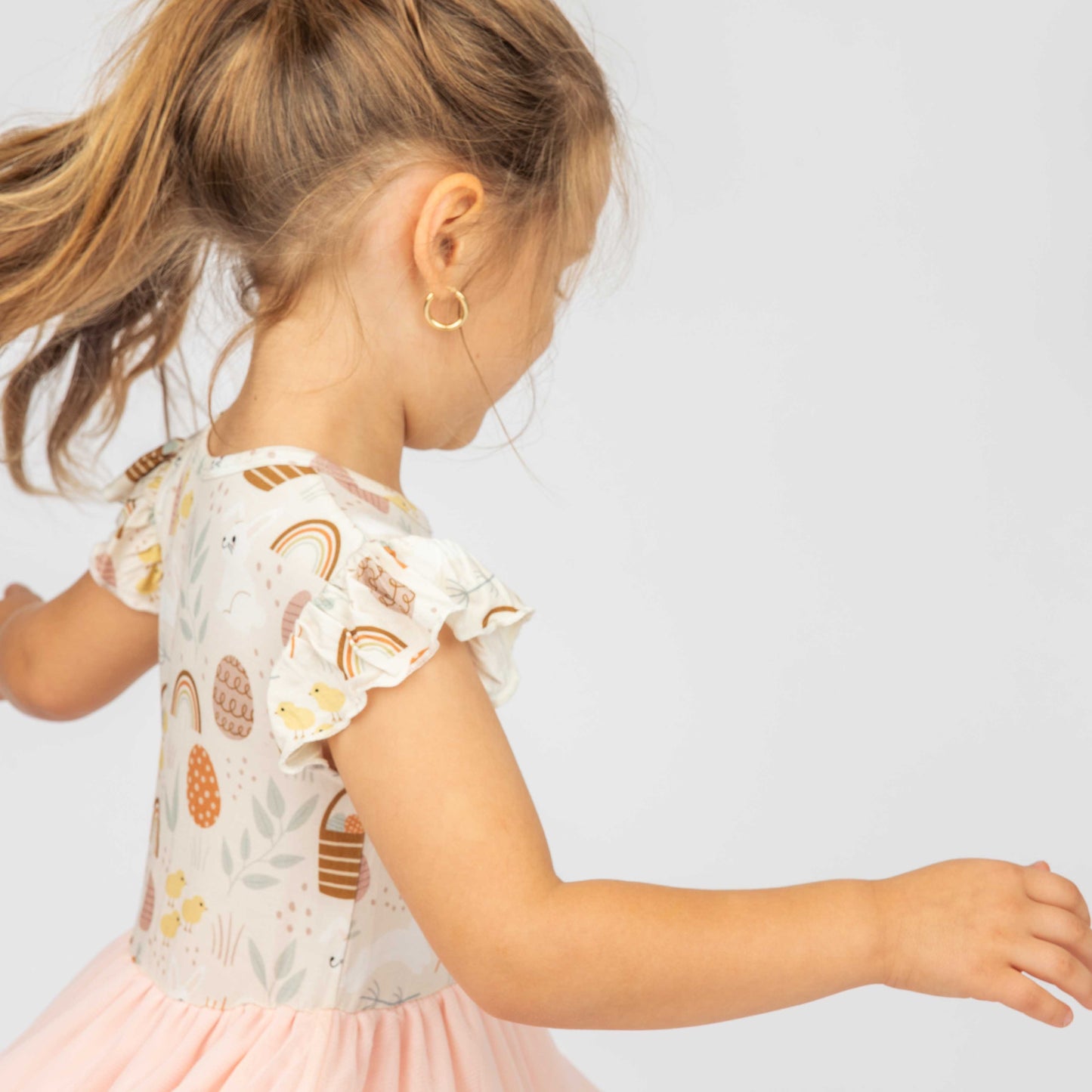 Close up of our hop to it print in the style of our Tulle bamaboo dress. The little girl is twirling around