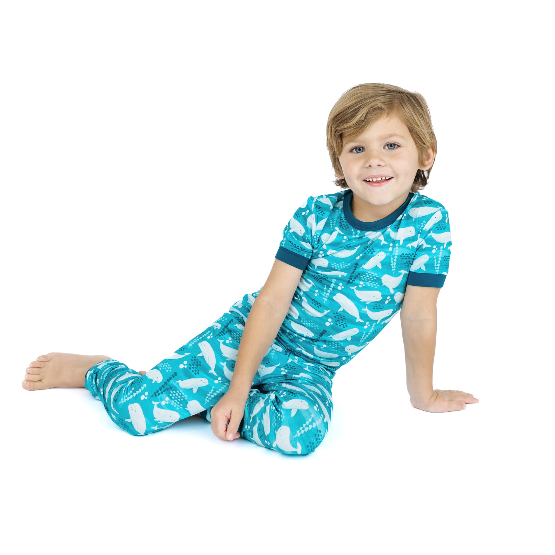 Child wearing a blue pajama set with white patterns on a white background