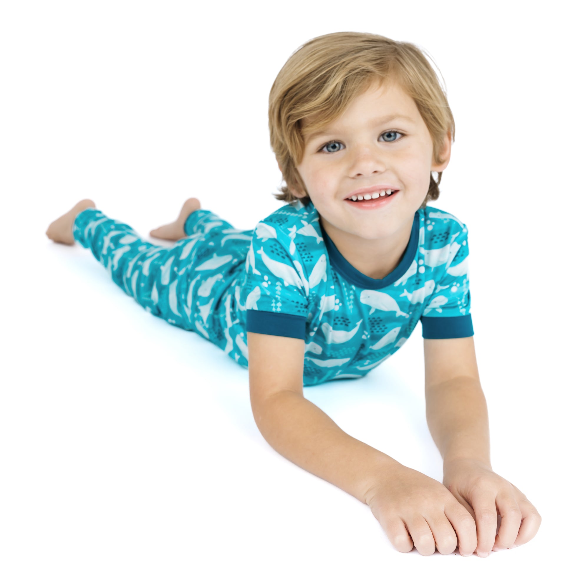Child wearing a blue and white patterned pajama set on a white background