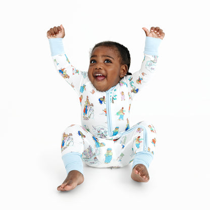 Child wearing a colorful onesie with cartoon characters on a white background