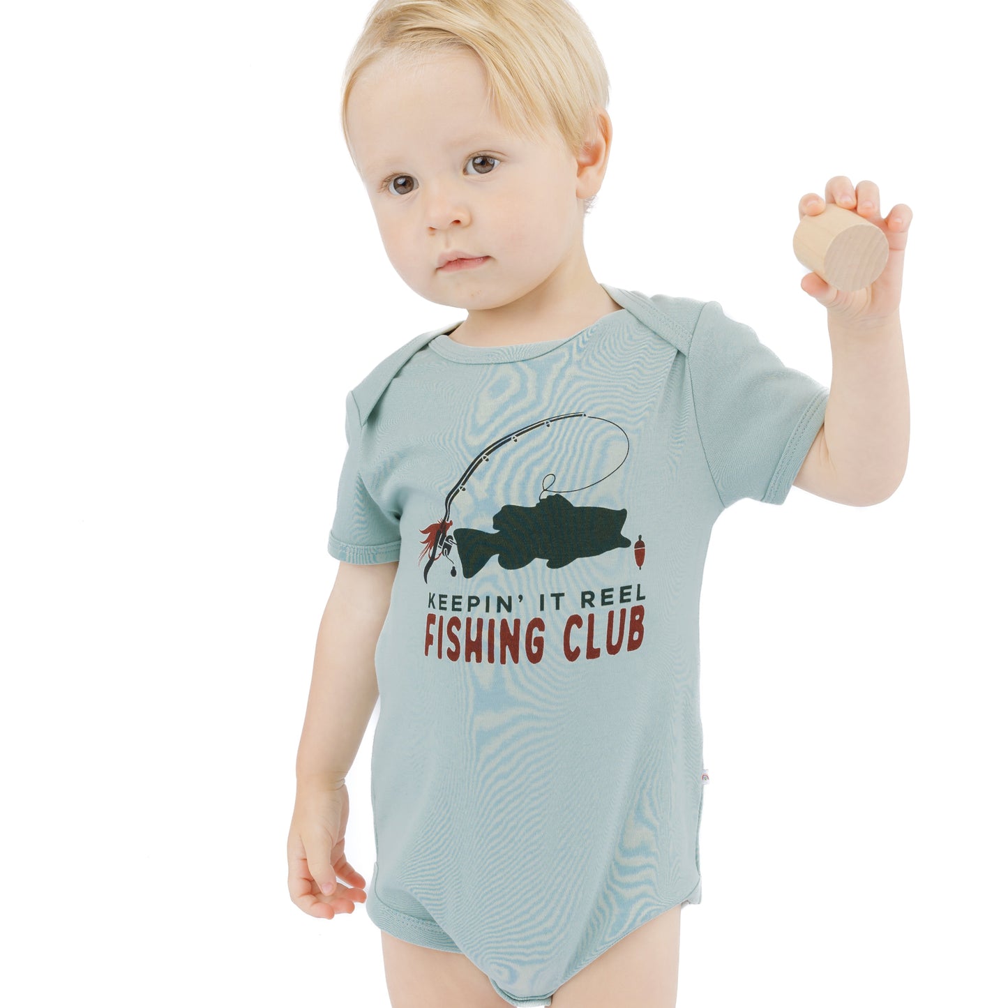 little boy in blue onesie with fish print