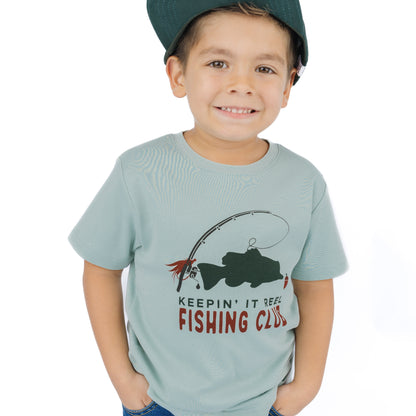 little boy wearing blue tee with fish graphic