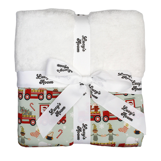 the "christmas train" bamboo and fleece blanket. the "christmas train" pattern has various winter character that stand/ride on a red train. these characters include: santa, santa's elves, raindeers, yeti monsters, gingerbreads, reindeer, christmas trees, candy canes, presents, and snowflakes. 