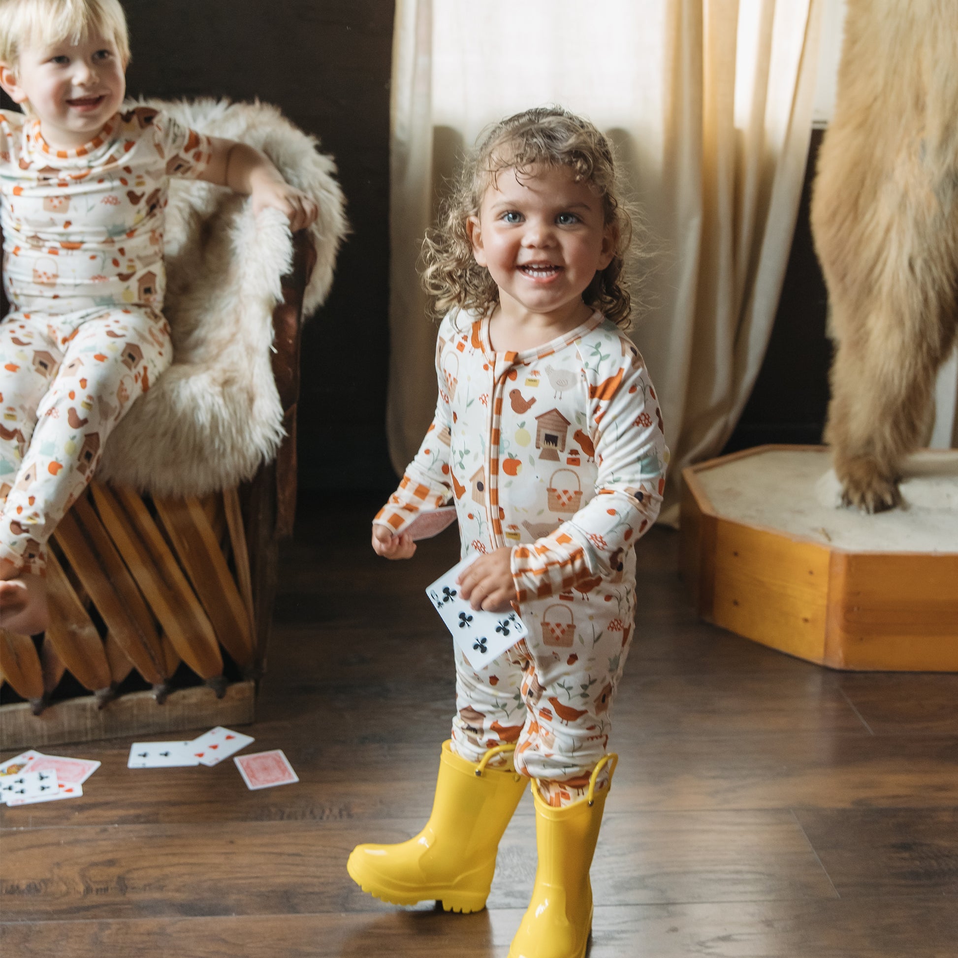 Baby and toddler bamboo zipper pajamas in Cozy Cottage farm print with barn, apple and chickens.