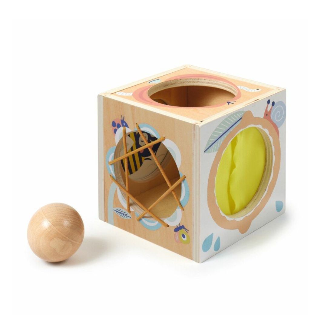 Wooden block with a hole and a ball on a white background