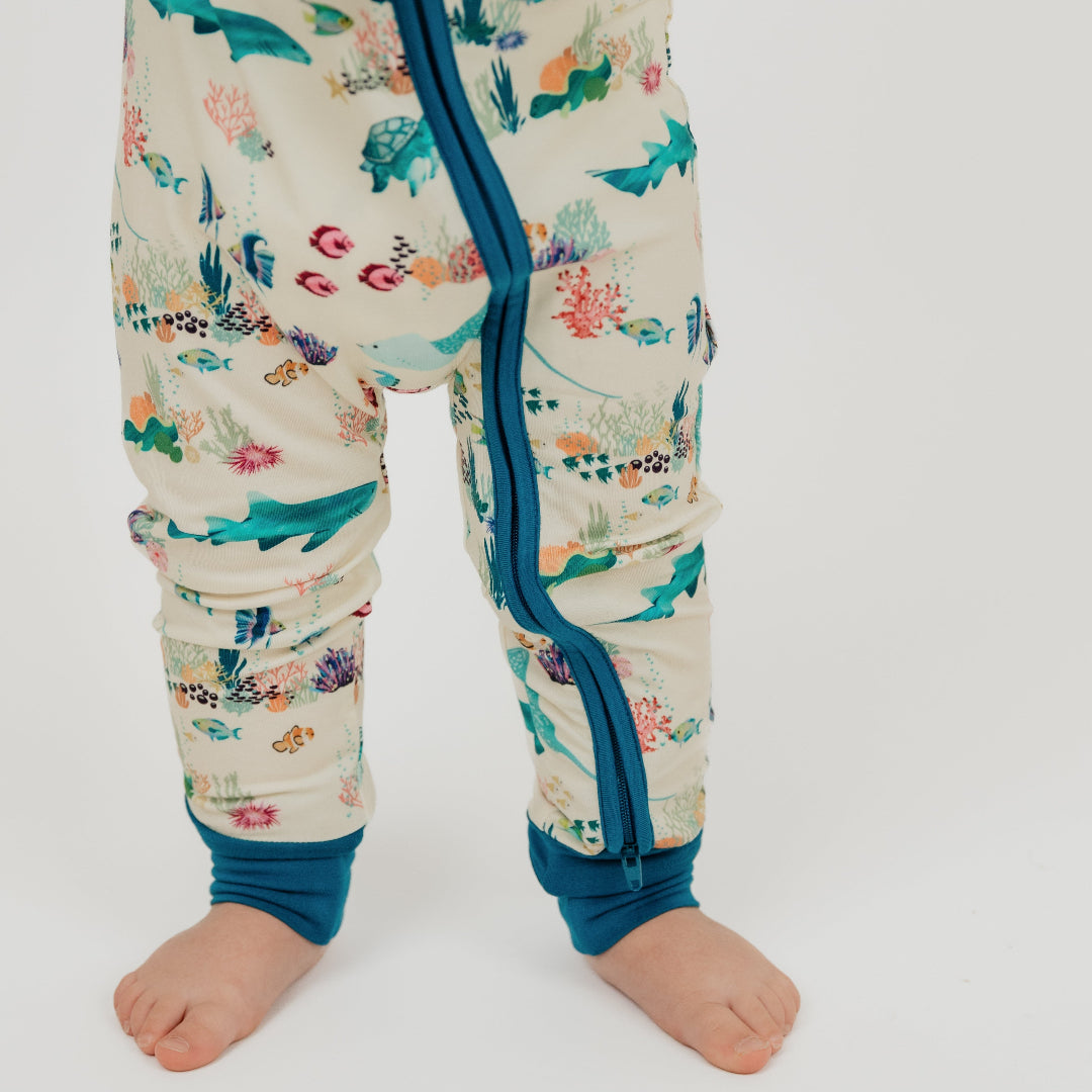 Coral reef print bamboo baby girl convertible and a double-sided zipper with blue trim, inspired by ocean creatures like fish, coral, and jellyfish.