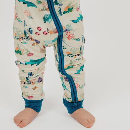 Coral reef print bamboo baby girl convertible and a double-sided zipper with blue trim, inspired by ocean creatures like fish, coral, and jellyfish.