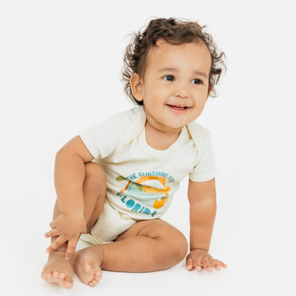 Florida Sunshine State baby onesie – soft & stretchy 100% cotton with unique vintage-inspired print, snap bottom, and fold-over shoulders for easy dressing.