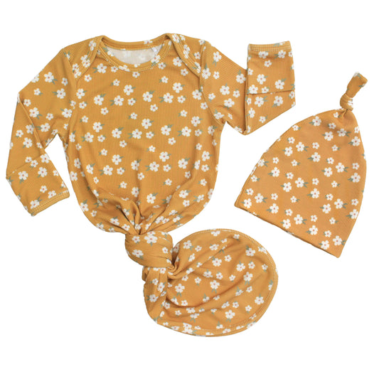 mustard yellow baby gown with white flowers on white background.