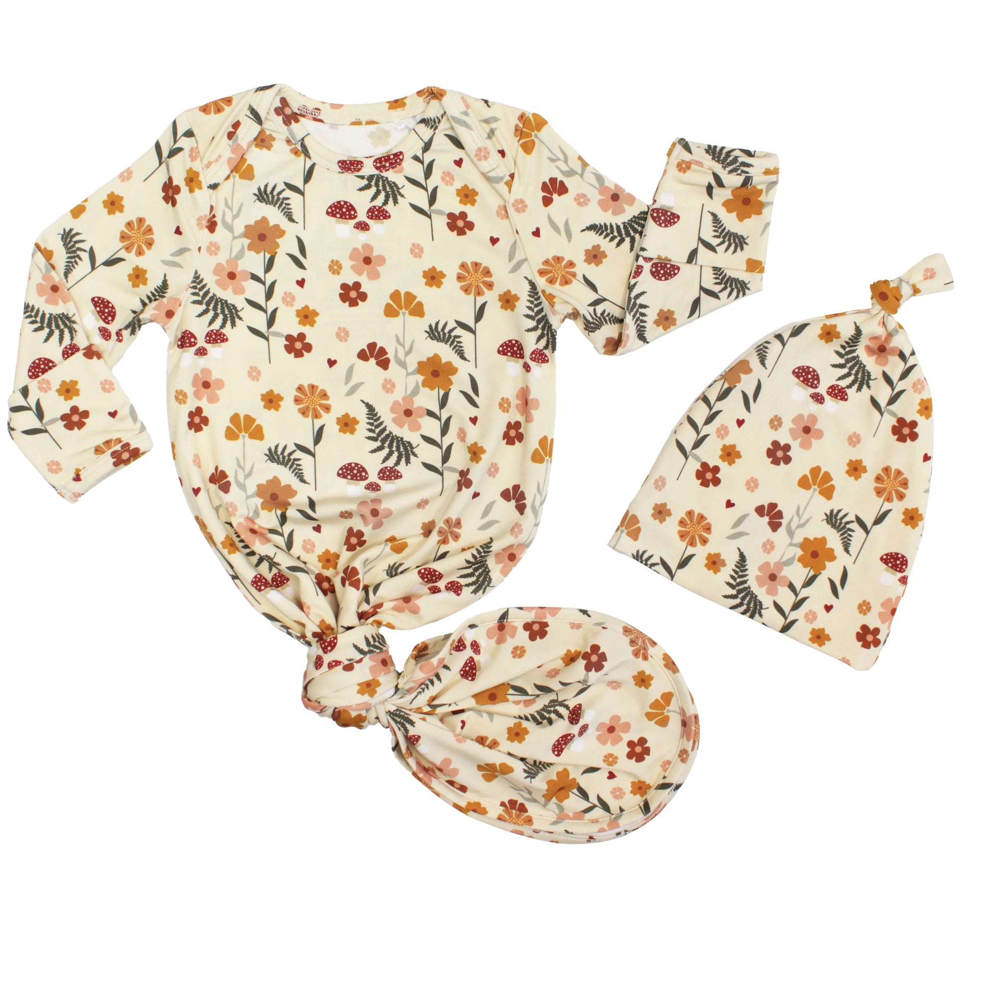 cream baby gown with mushroom print on white background.