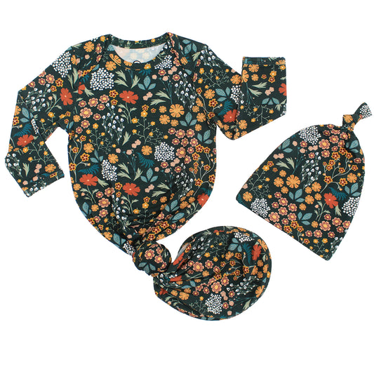 dark green baby gown with floral print on white background. 