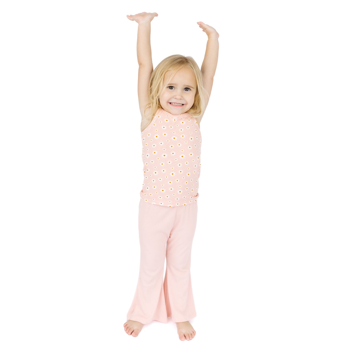 Young girl wearing a pink outfit with a white background