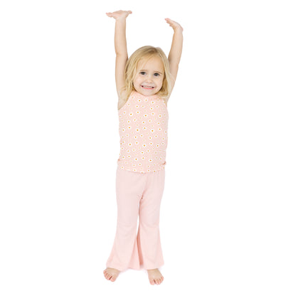 Young girl wearing a pink outfit with a white background
