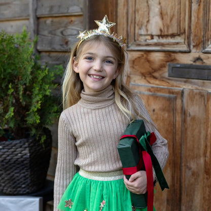 Young girl wearing the gold glittery stars and tinsel headband from Great Pretenders 