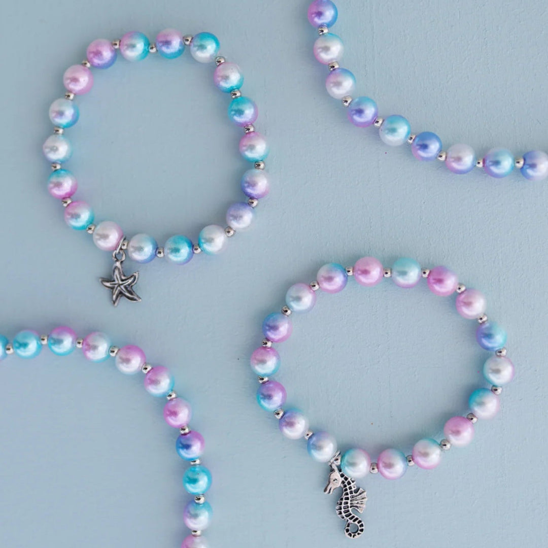 Set of two bracelets with iridescent blue, purple and pink beads and silver charms featuring a seahorse and starfish from Great Pretenders