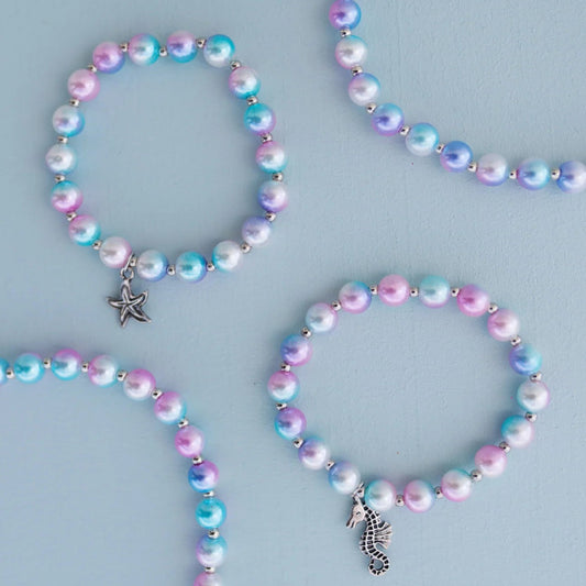 Set of two bracelets with iridescent blue, purple and pink beads and silver charms featuring a seahorse and starfish from Great Pretenders