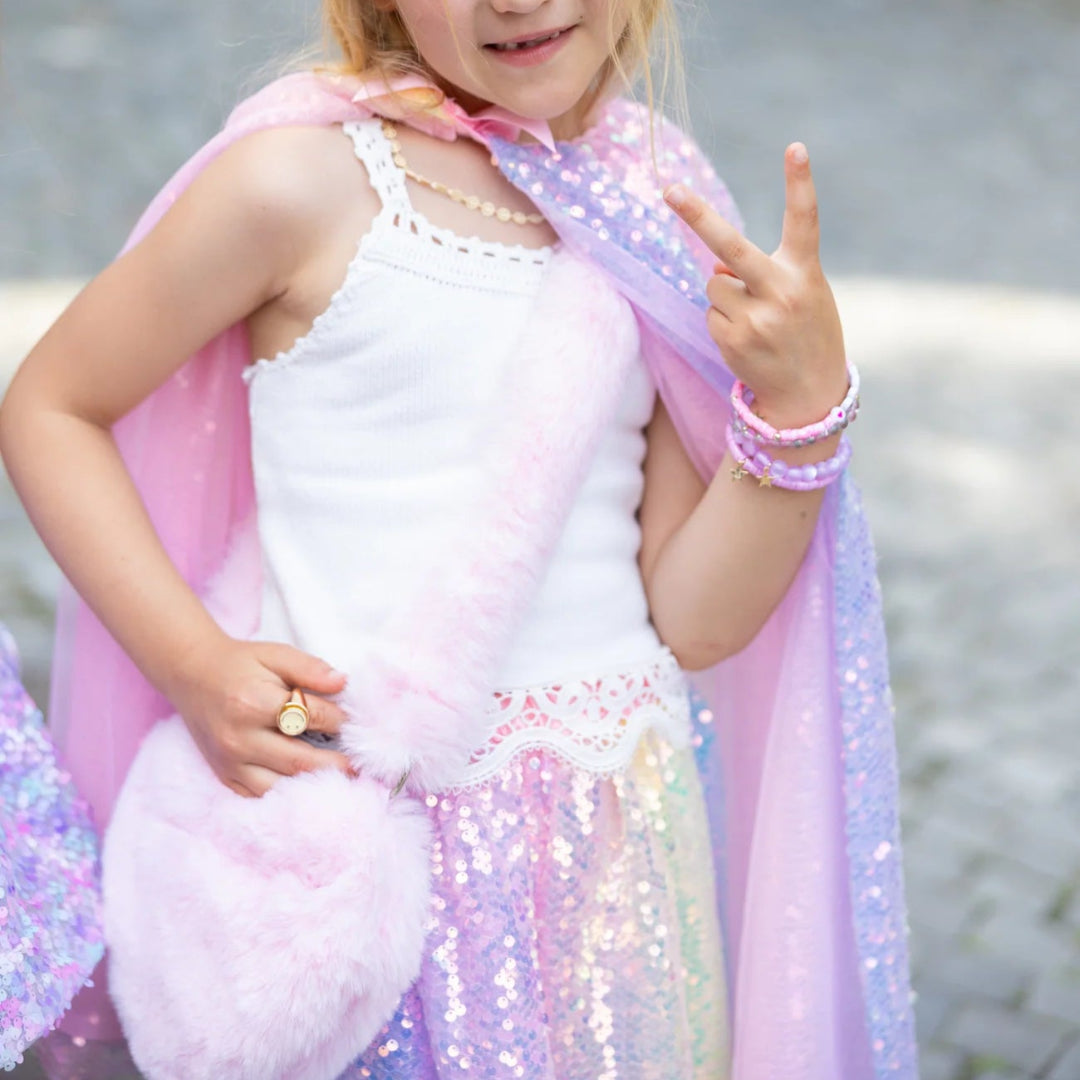 Young girl carrying the light pink furry heart shaped purse from Great Pretenders