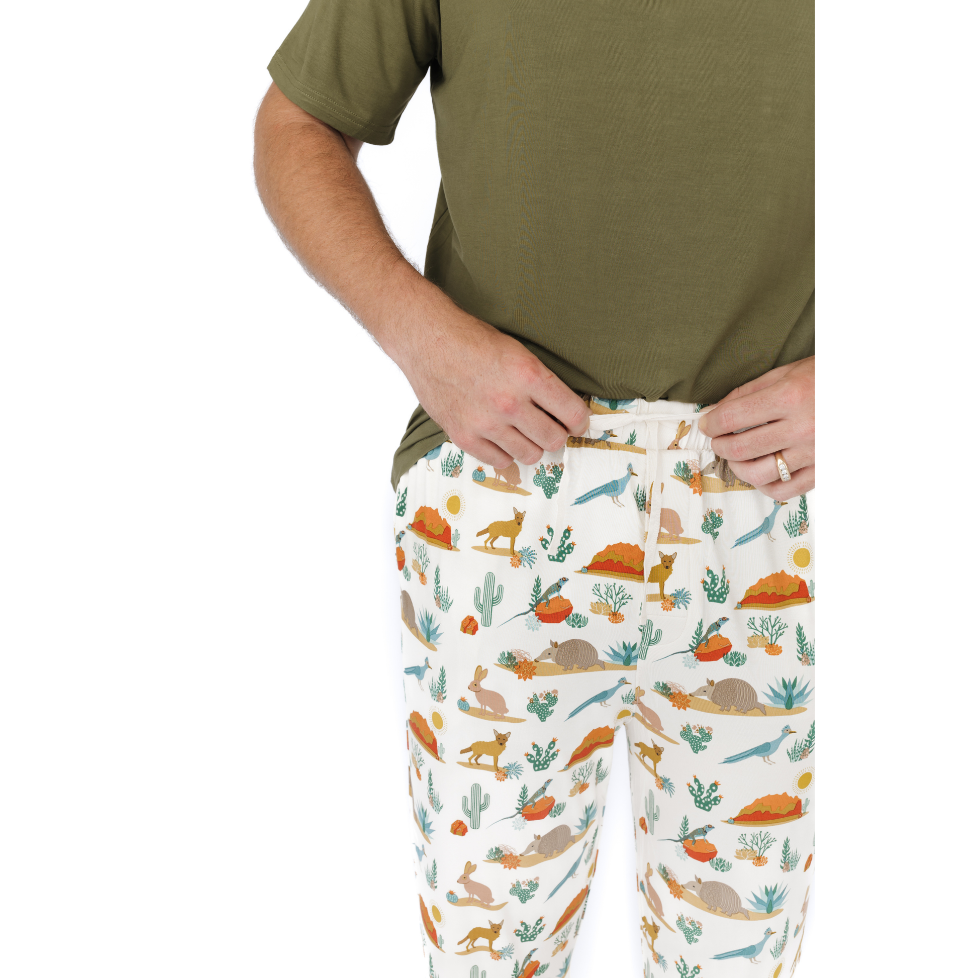 Person wearing a green shirt and white pants with nature-themed pattern on a white background