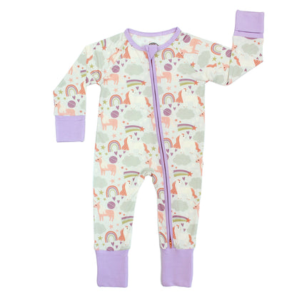 Flat lay of our Magical Unicorn Bamboo Convertible Pajama. The print includes unicorns, rainbows, clouds, planets, stars, and hearts. The colors are purple, pink, and blu, with hints of green. 